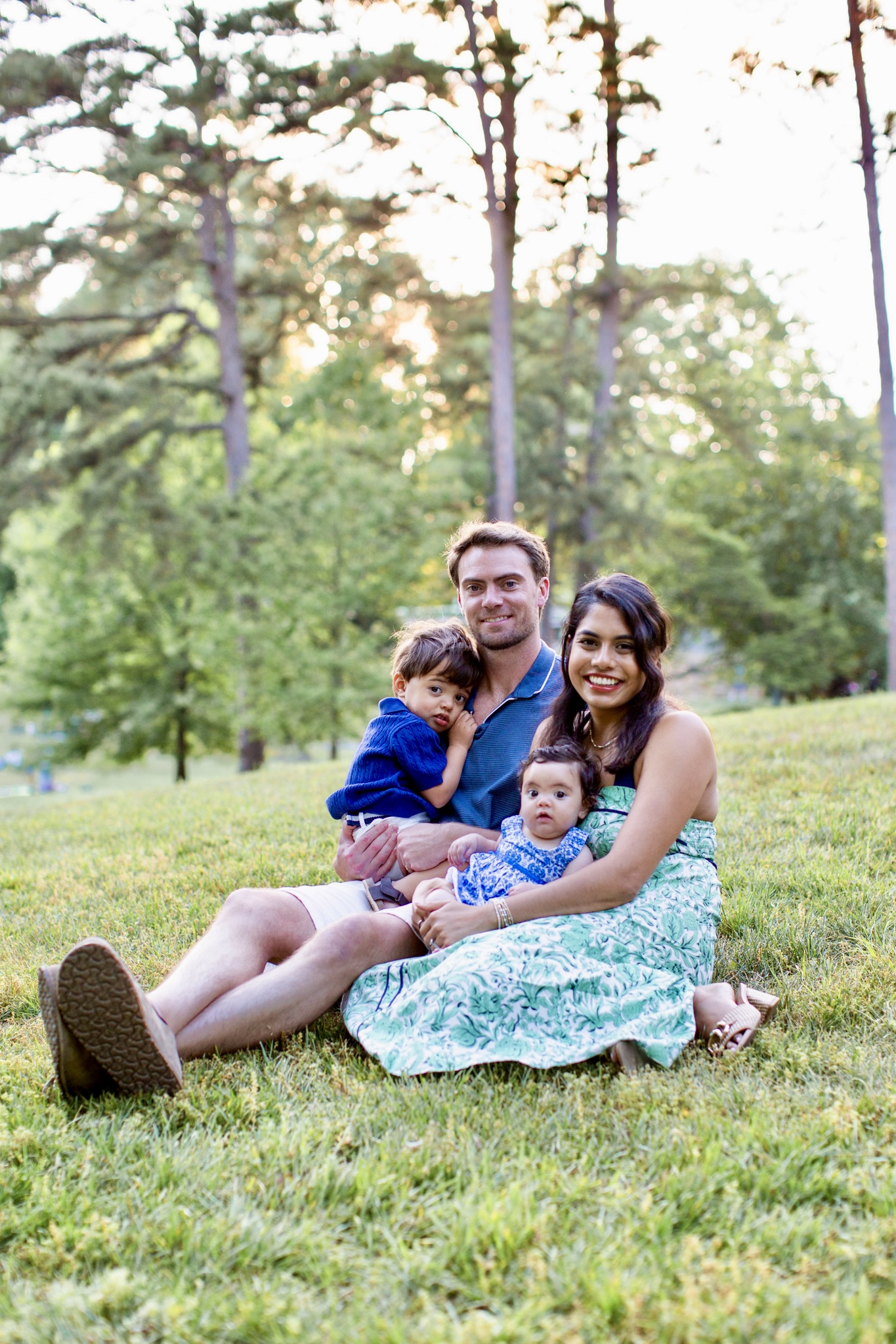 Dr. Daly seated outdoors with her husband and their two young children