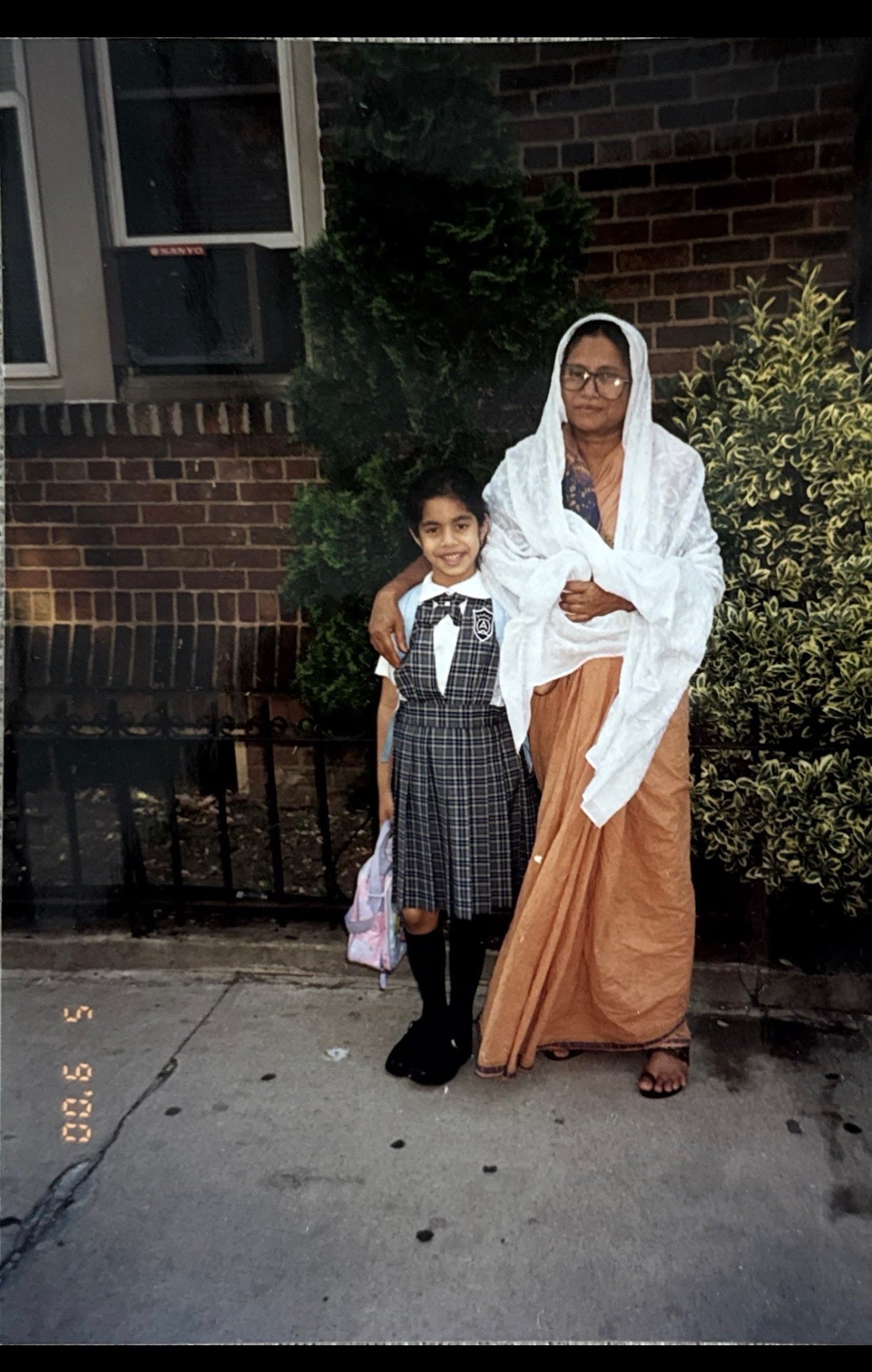 Young Dr. Shaoleen Daly standing beside her paternal grandmother, Dadimoni